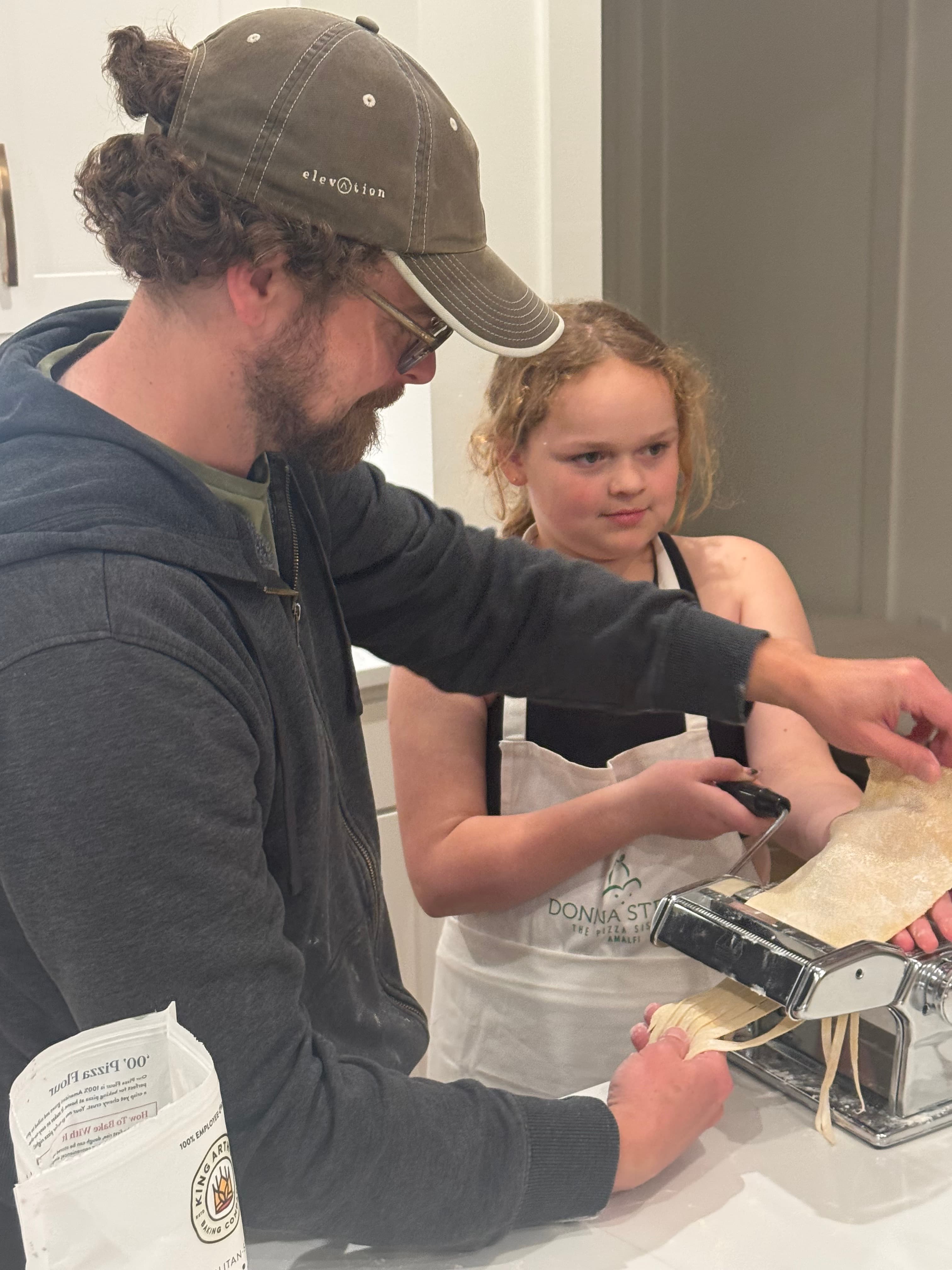 Guests cooking and connecting at Lou's LIFE cooking experience