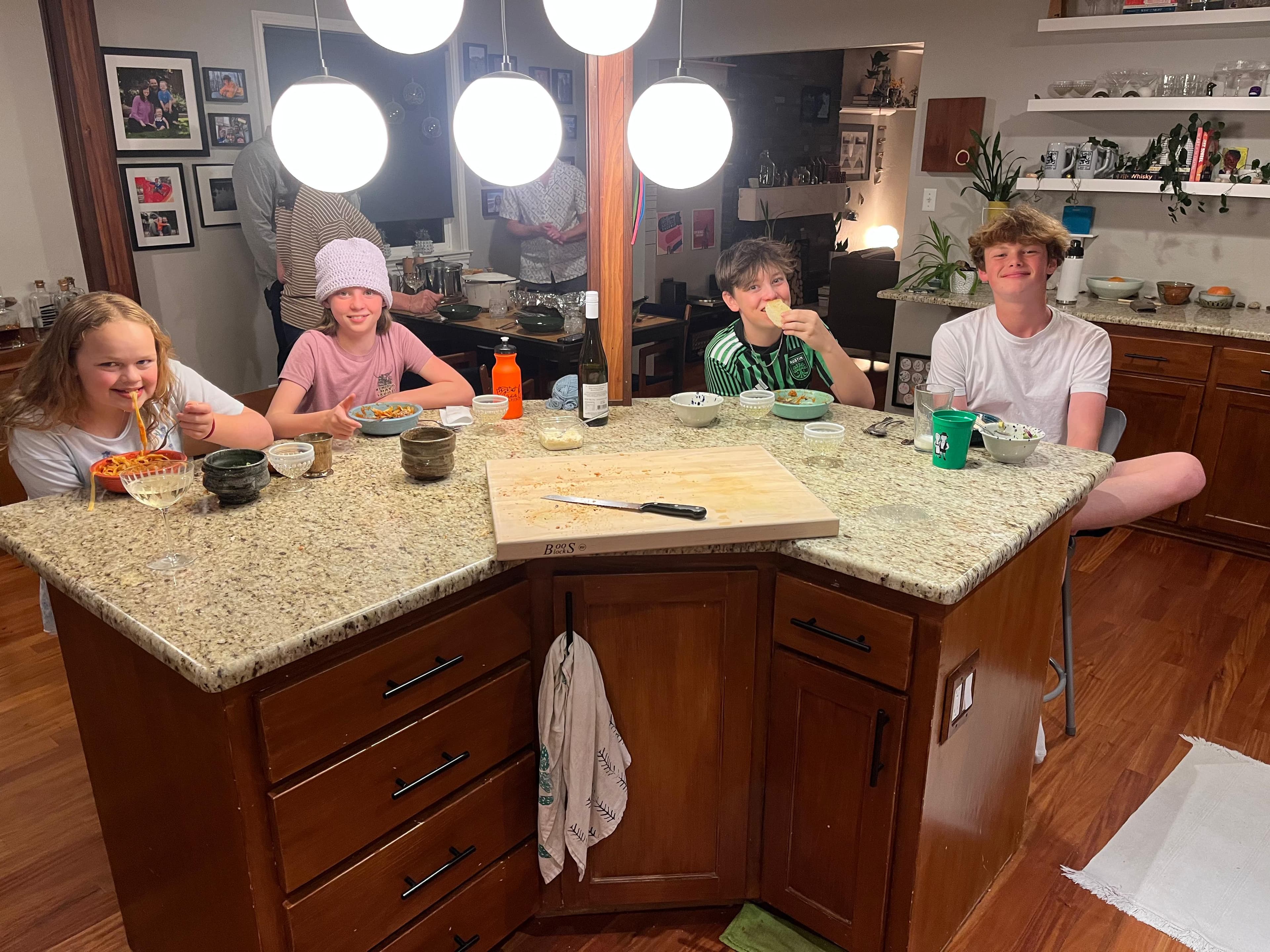 Neighbors gathered in Kim's kitchen for a LIFE cooking experience in Austin