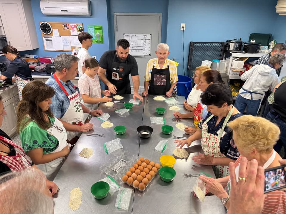 Participants preparing pasta together during the Buoni Amici Lodge 3021 class at Cokes Chapel