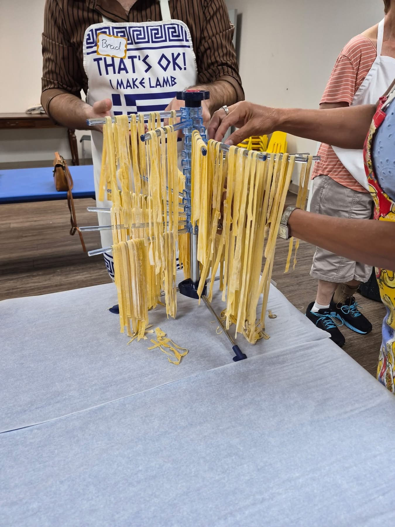 Buoni Amici Lodge 3021 pasta class participants cooking together in the Cokes Chapel kitchen