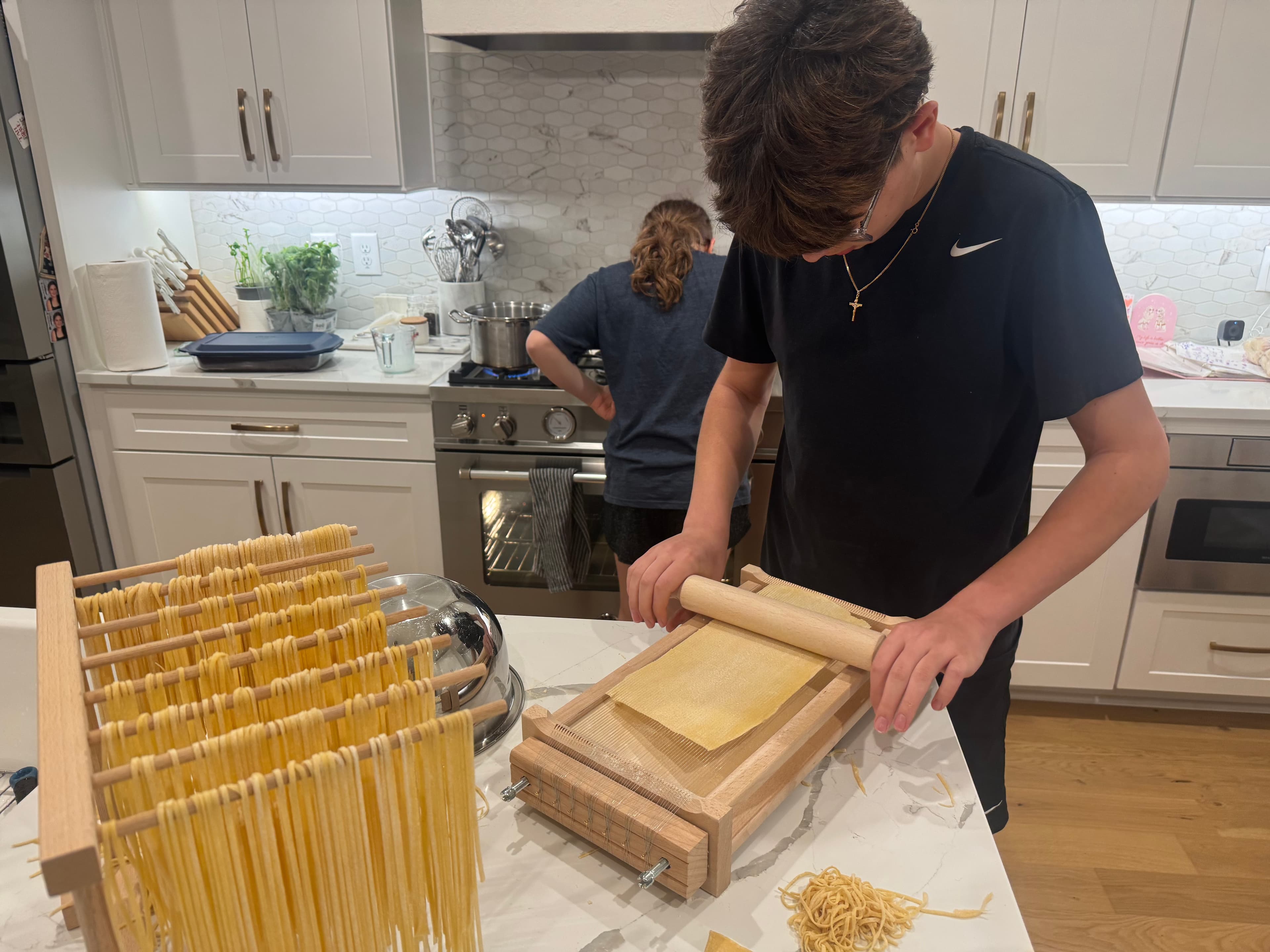 Kids shaping pasta at the table